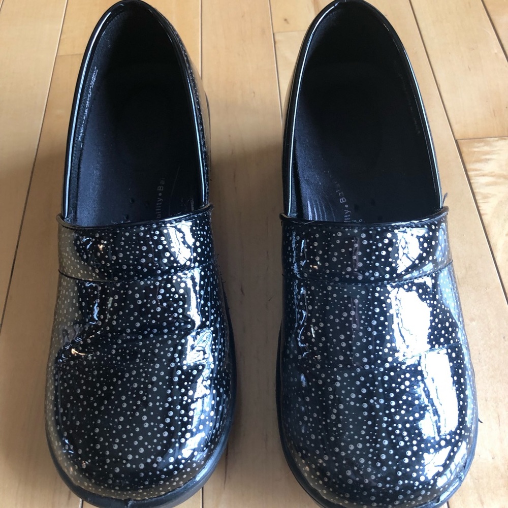 Black and silver clogs